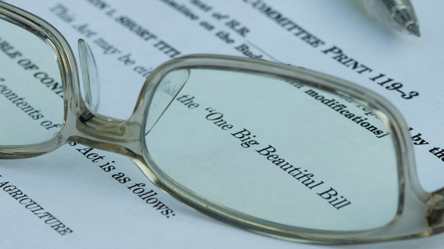 Glasses laying on paper showing "The Big Beautiful Bill"