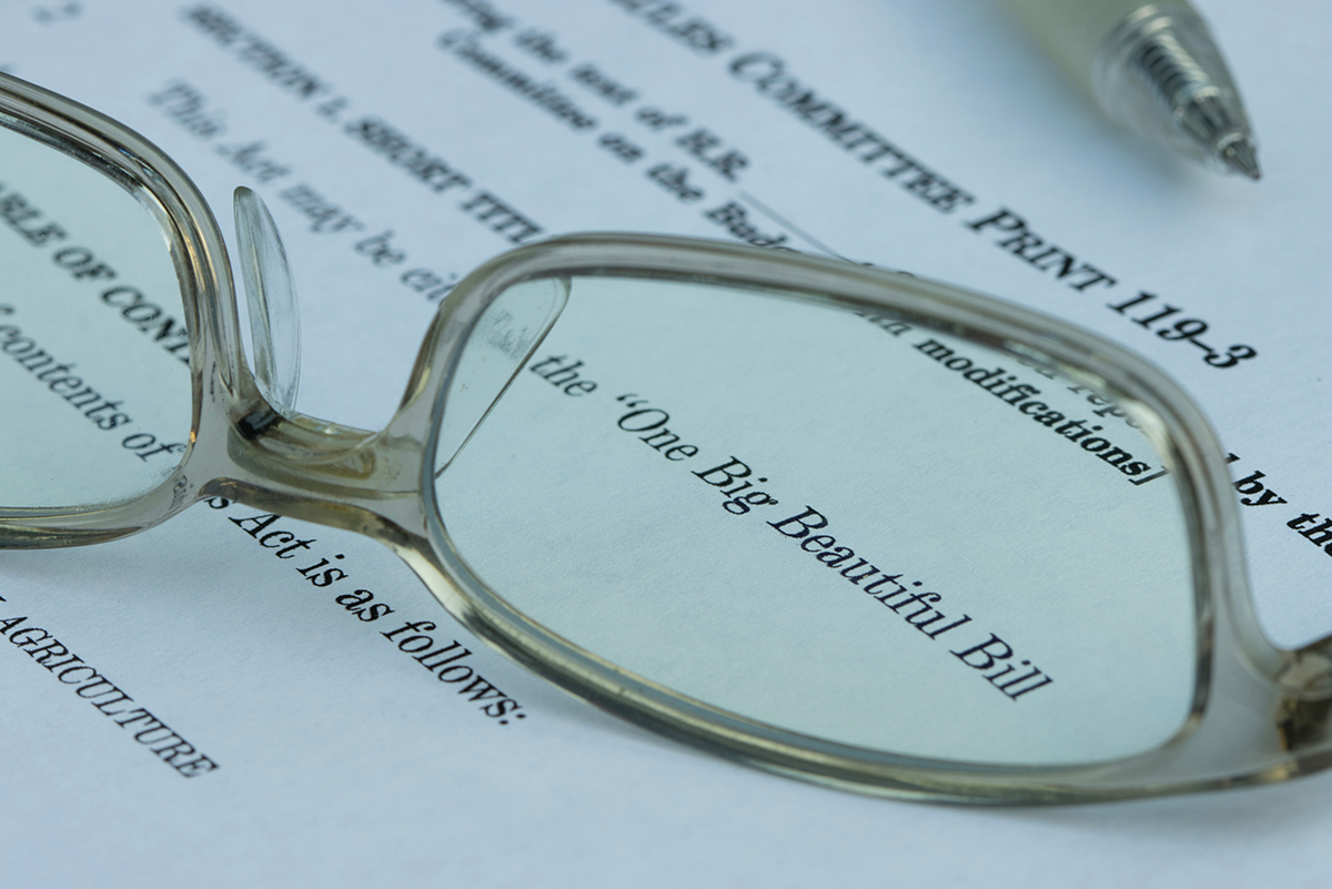 Glasses laying on paper showing "The Big Beautiful Bill"